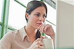 Young female office worker looking at laptop