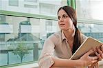 Young female holding at digital tablet in office