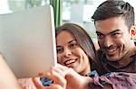 Young couple looking at digital tablet