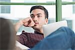 Close up of young man at home with digital tablet