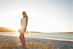 Blond woman posing on beach at dusk, Cape Town, South Africa