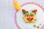 Face made from fresh food on slice of bread