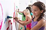 Group of girls painting wall