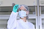 Female scientist examining petri dish