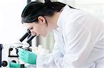 Close up of female scientist examining at test tube