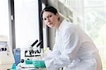 Portrait of female scientist using laboratory equipment