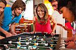 Friends playing table football