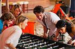 Friends having fun playing table football