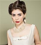 Portrait of woman in vintage clothes and pearls