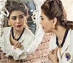 Woman in vintage clothes looking in mirror