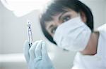 Close up portrait of dentist holding syringe