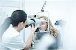 Optician and patient in eye clinic