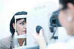 Close up of optician monitoring patient in eye clinic