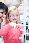 Young girl pointing to eyeglasses