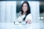 Woman and a pair of eyeglasses