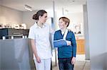 Nurse with young patient in reception