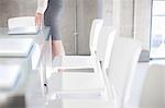 Young woman preparing boardroom table