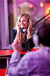 Young man and woman broadcasting in recording studio