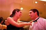 Mid adult woman and young man laughing in dance class