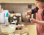 Child holding spoon with cake mix