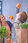 Young couple messing around in kitchen