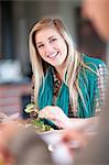 Young woman eating salad in kitchen