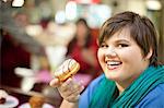 Portrait of young woman holding doughnut