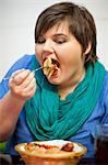 Young woman in cafe eating fries