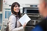 Woman looking at oven in showroom