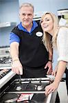 Young woman and salesman in showroom