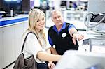 Young woman and salesman in showroom