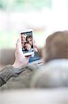 Man looking at family photo on cellphone