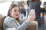 Young woman using cellphone for video call