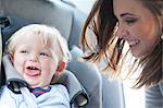 Mother with baby son in back seat of car