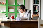 Man writing at desk