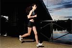 Young woman running at sunset