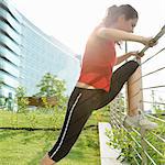 Young woman runner stretching