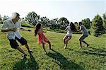 Group of young adults playing tug of war