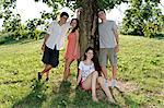 Portrait of young adults next to a tree