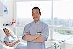 Portrait of nurse standing in front of patient