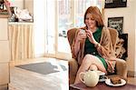 Portrait of young woman using smartphone in cafe