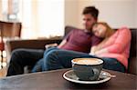 Young couple lounging on cafe sofa