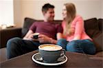 Young couple lounging on sofa in cafe