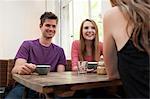 Group of friends chatting in cafe