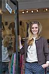 Woman standing in doorway of clothes shop