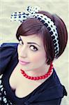 Close-up portrait of young woman outdoors, looking at camera, Italy