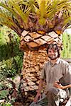 Portrait of man holding blade for peeling palm tree, Majorca, Spain