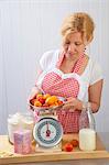 A woman weighing apricots