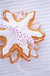 Pile of gingerbread stars garnished with icing and tied with bow