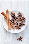 Star anise and cinnamon sticks on a plate